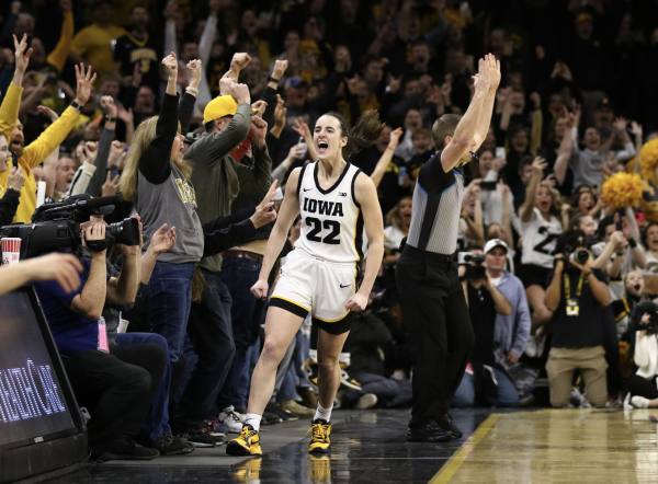 IOWA CITY, IOWA- FEBRUARY 15:  Guard Caitlin Clark #22 of the Iowa Hawkeyes celebrates after breaking the NCAA womens all-time scoring record during the first half against the Michigan Wolverines  at Carver-Hawkeye Arena on February 15, 2024 in Iowa City, Iowa.  (TNS Photo by Matthew Holst/Getty Images)
